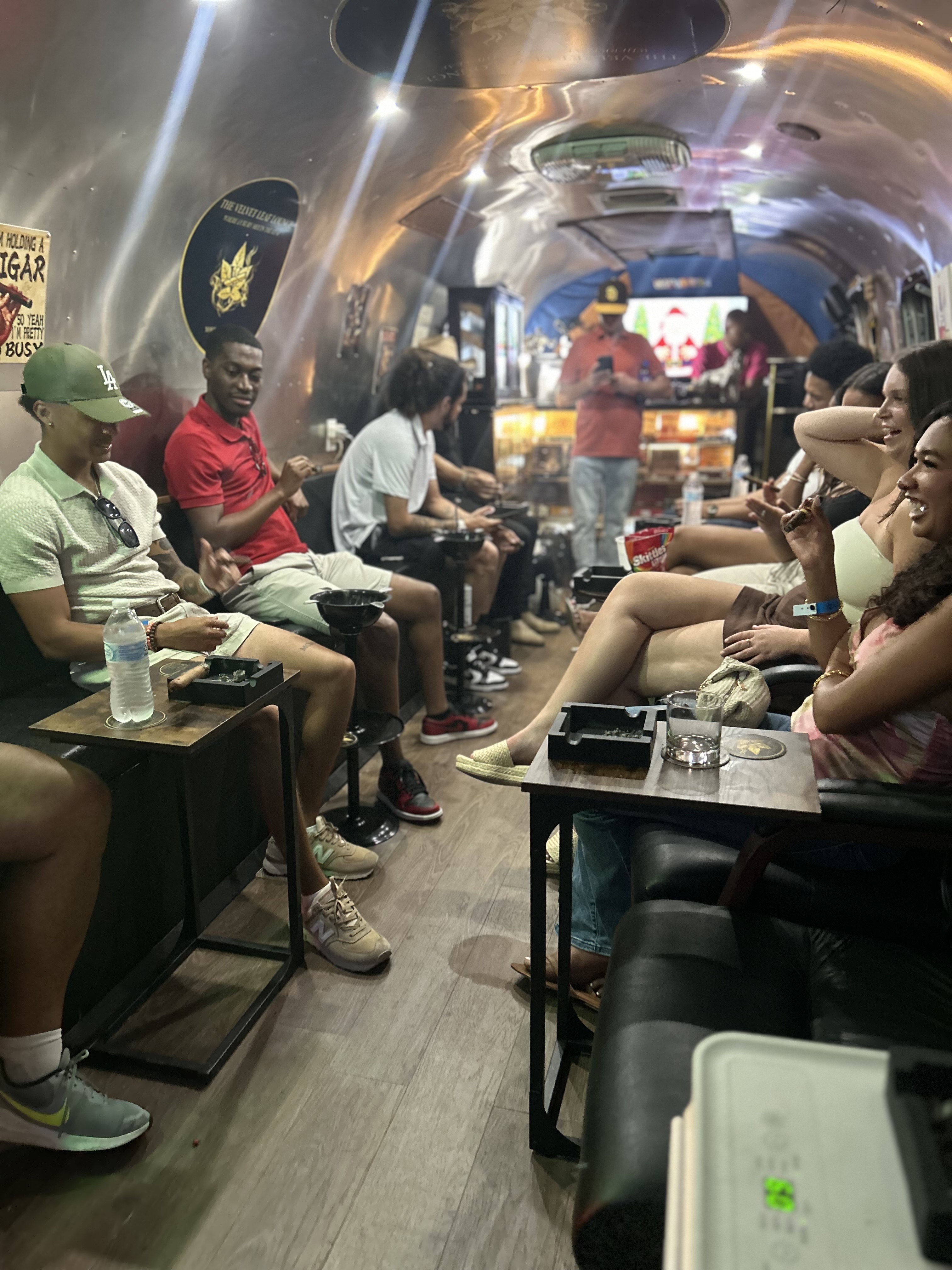 Guests enjoying cigars while watching TV inside the lounge