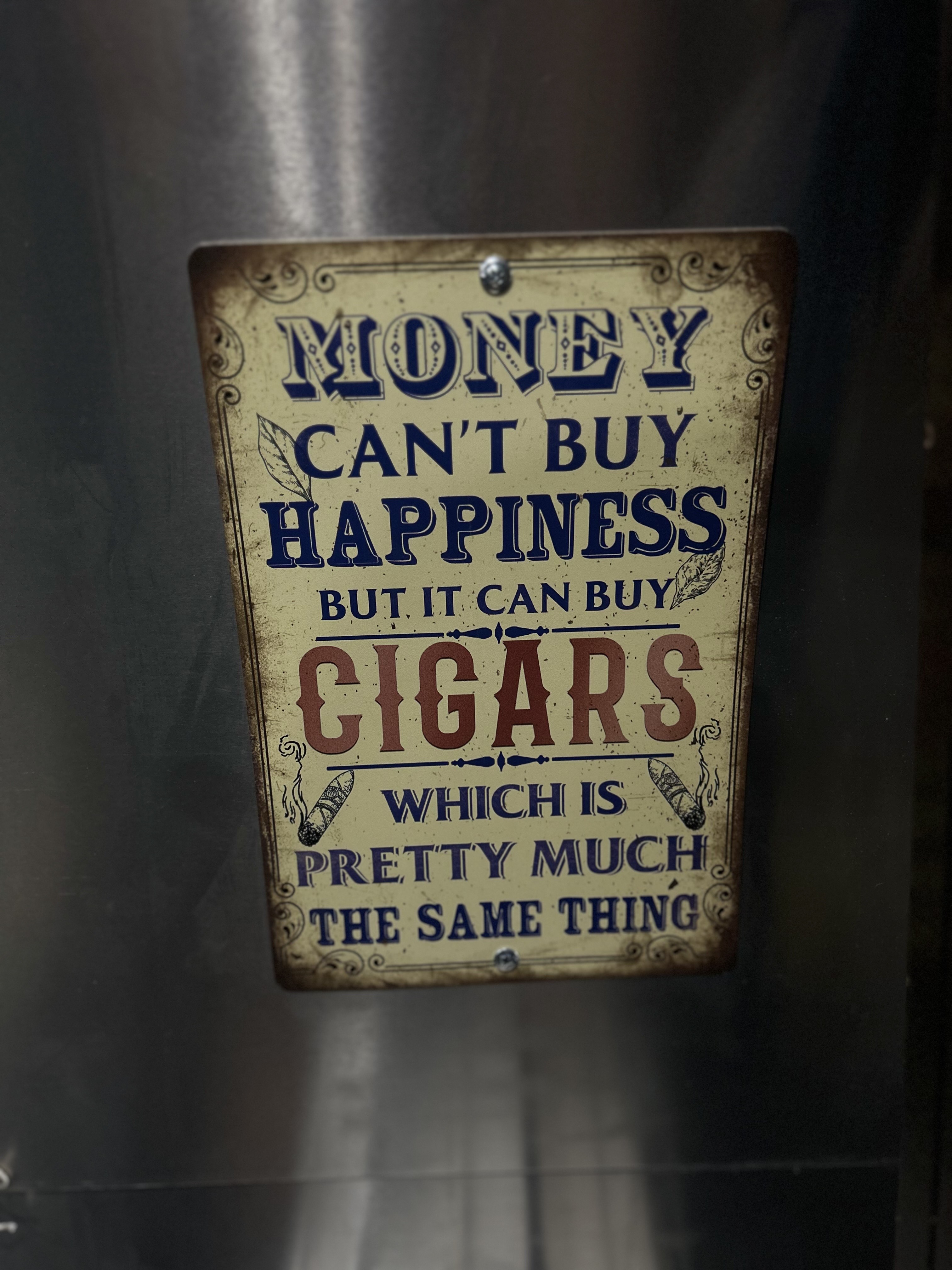 A vintage cigar-themed sign displayed inside the Airstream