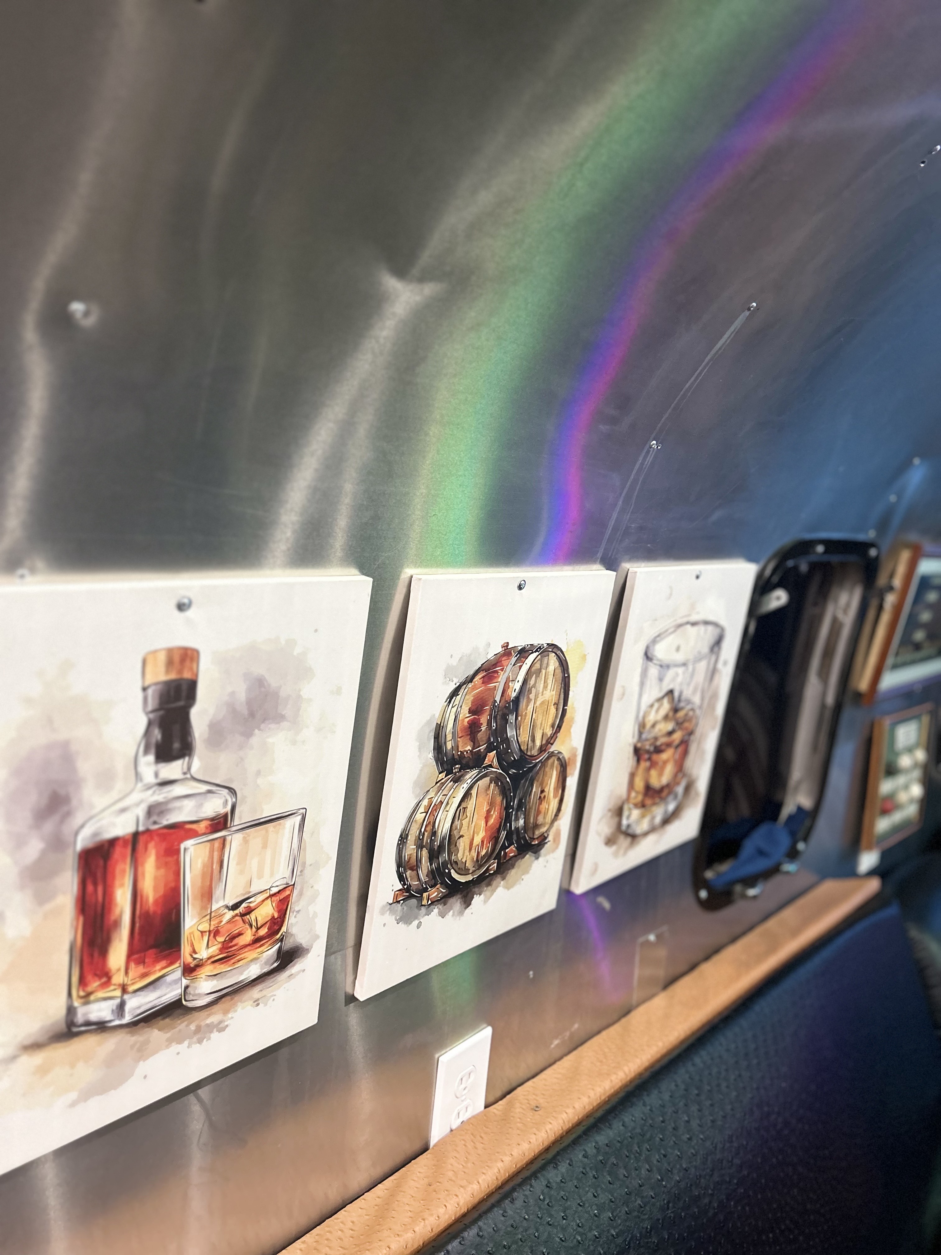 Hand-painted whiskey and cigar artwork lining the lounge wall